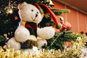 A white teddy bear in a Christmas tree.