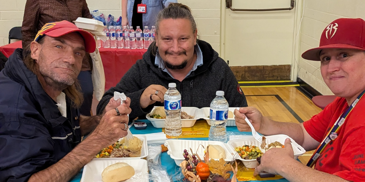 Community members enjoy a Thanksgiving meal 2024