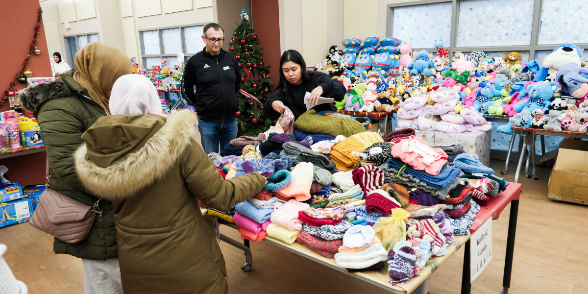 Image of parents selecting gifts for their children at the YSM Toy Market 2025